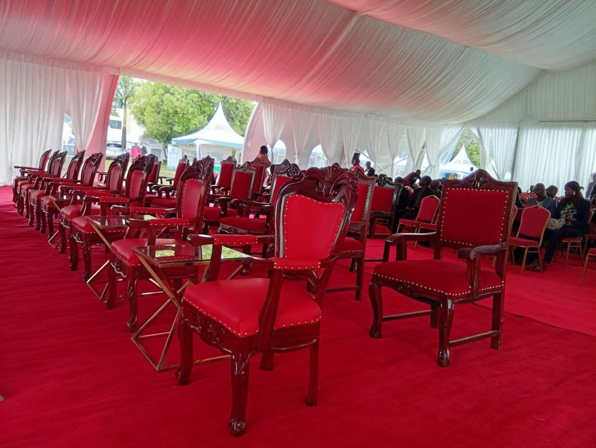 VIP chairs and side tables under a marquee